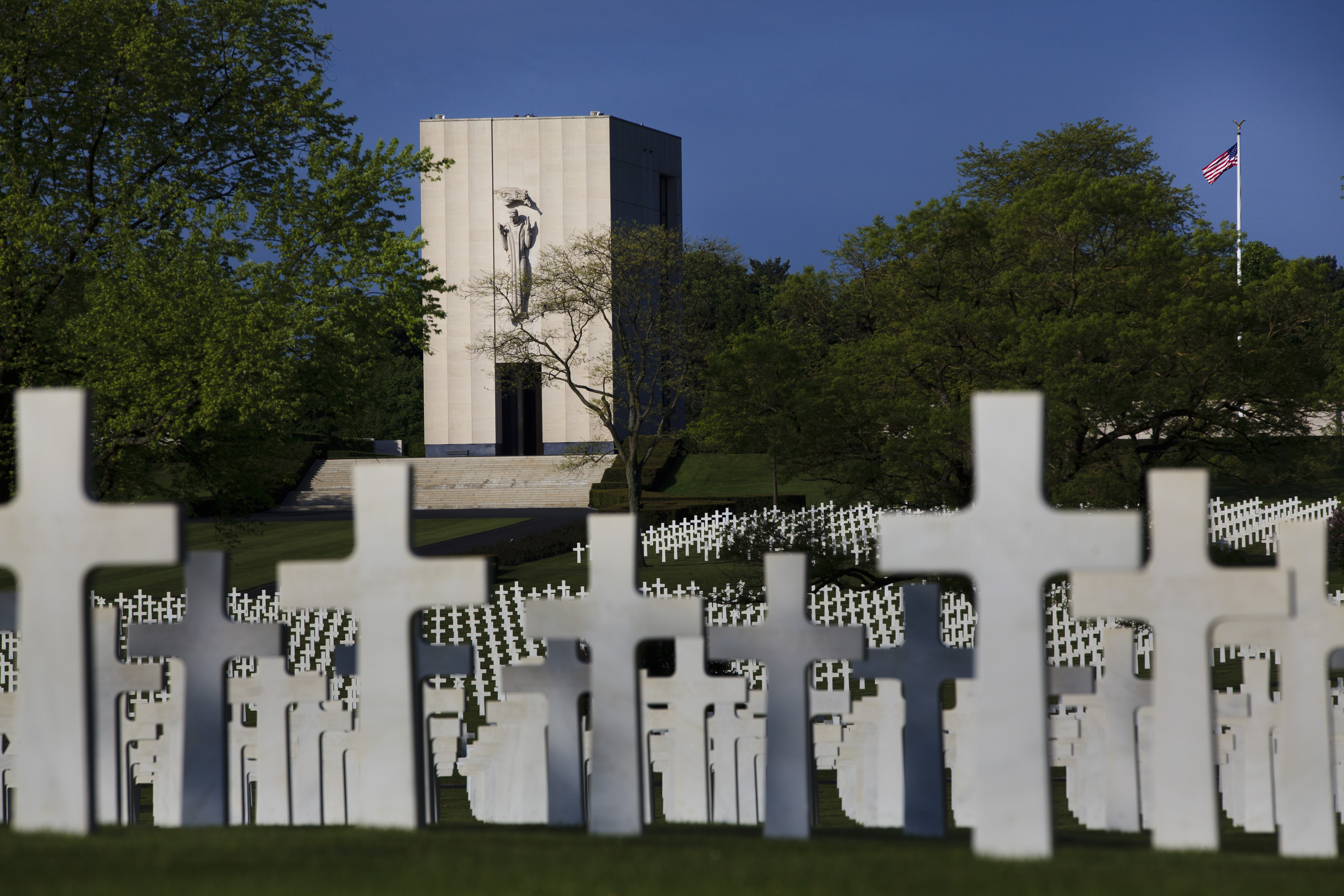 Marble headstones fill the landscape in front of the chapel at Lorraine American Cemetery. 