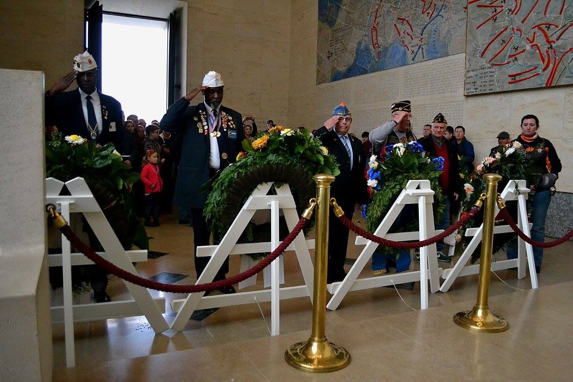 Men salute after laying wreaths in the chapel. 