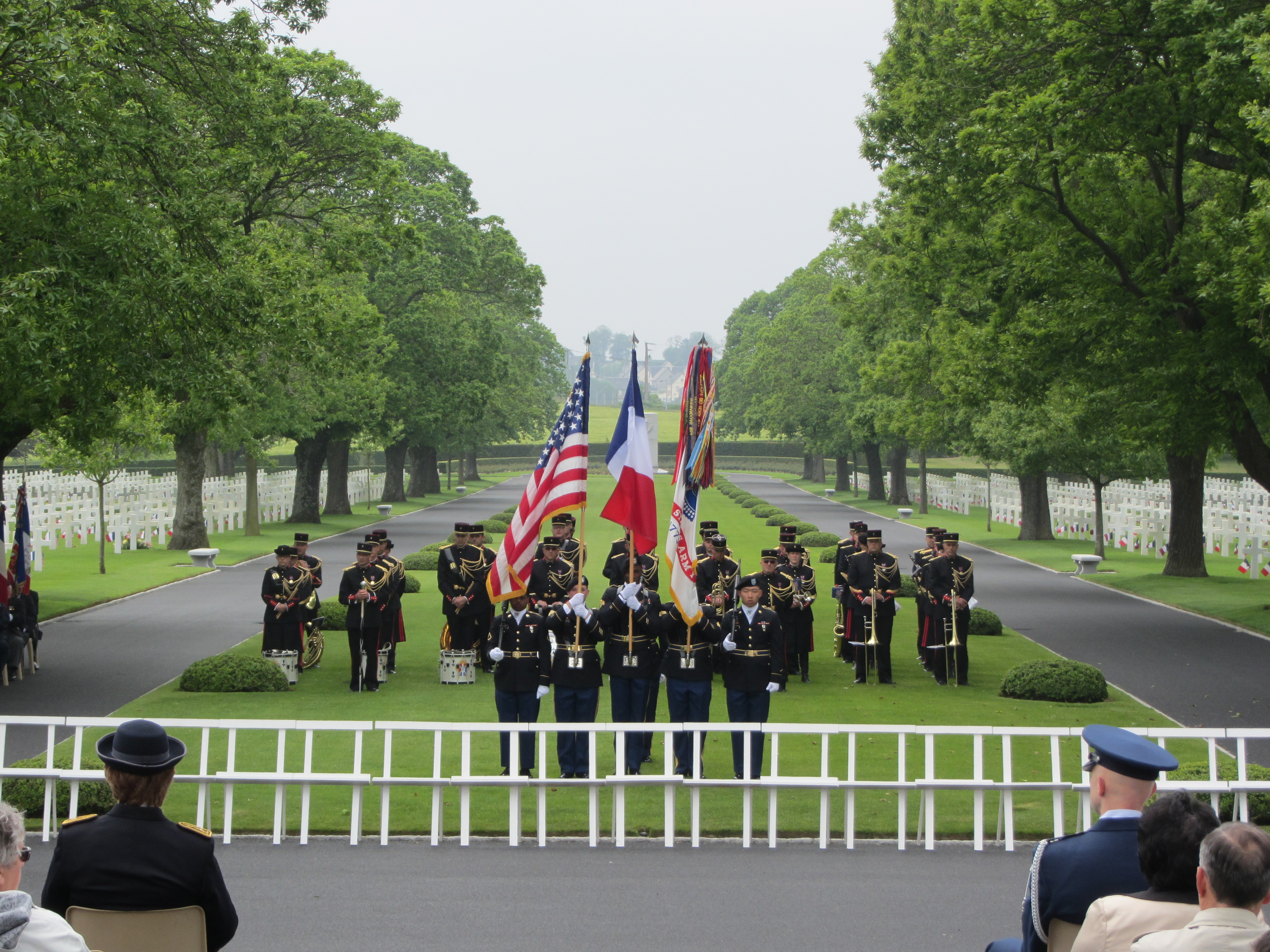 A U.S. Color Guard stands in the forefront, with the band in the background.