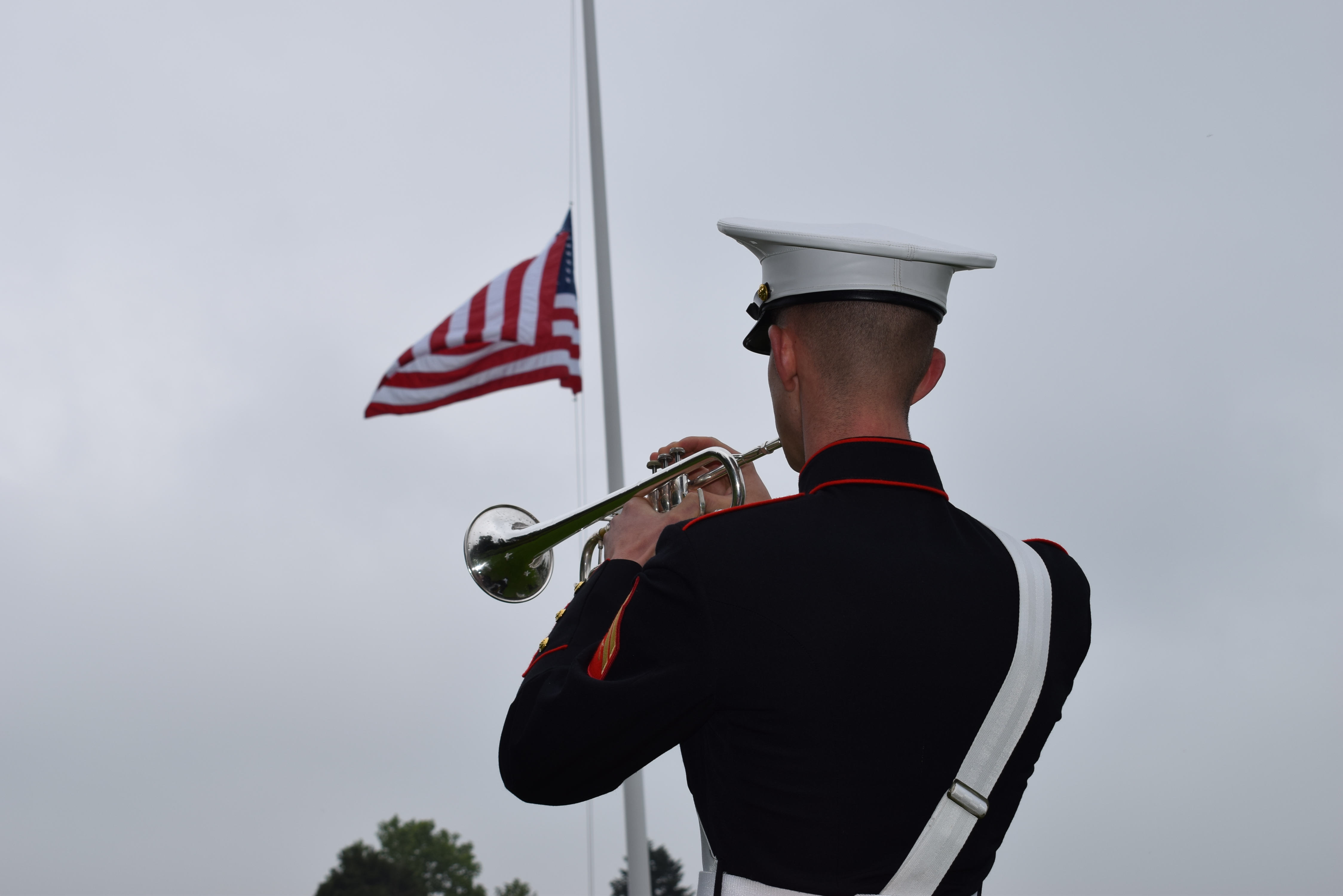 A Marine plays the trumpet during the ceremony.
