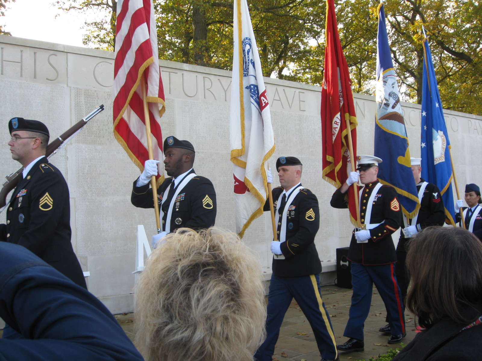 A Joint Honor Guard marches in front of the Walls of Missing during the ceremony. 