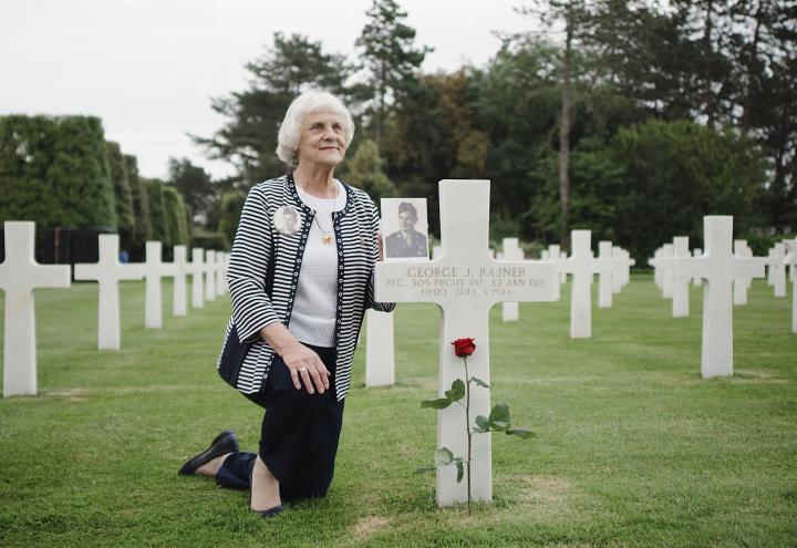 Carol LaBounty at her father's grave at Normandy American Cemetery