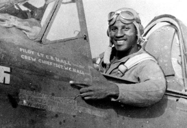 Historic photo showing Hall sitting in the cockpit of his fighter. 