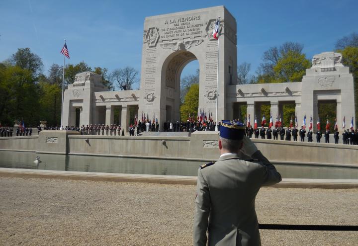A member of the French military salutes as he faces the memorial. 