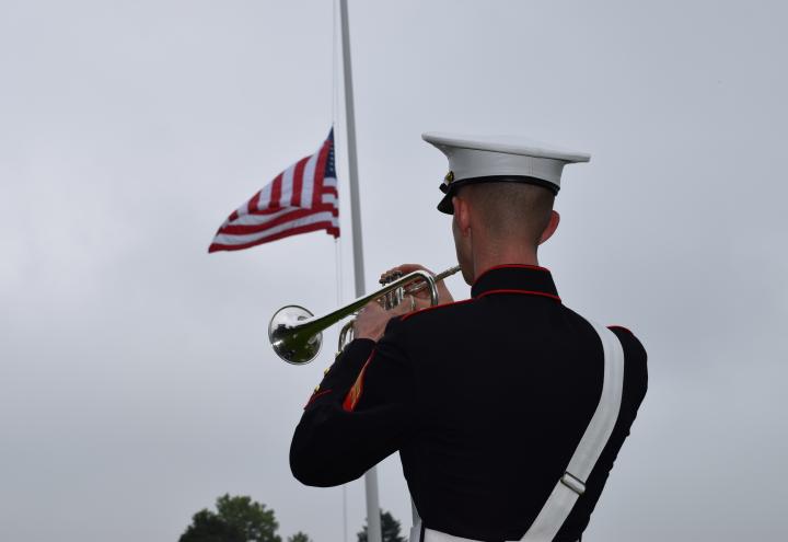 A Marine plays the trumpet during the ceremony.