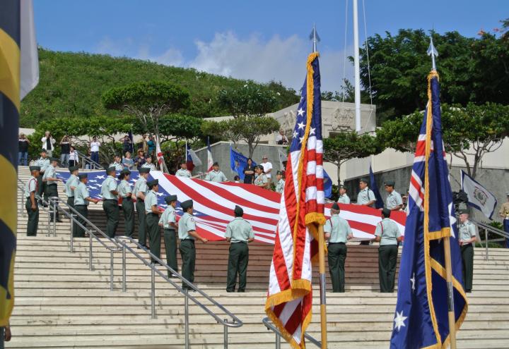 Members of the military fold a large American flag on the steps of the Honolulu Memorial, Veterans Day 2011.