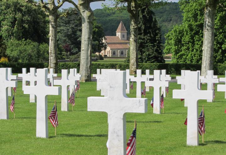 American and French flags stand in front of every marble headstone. 