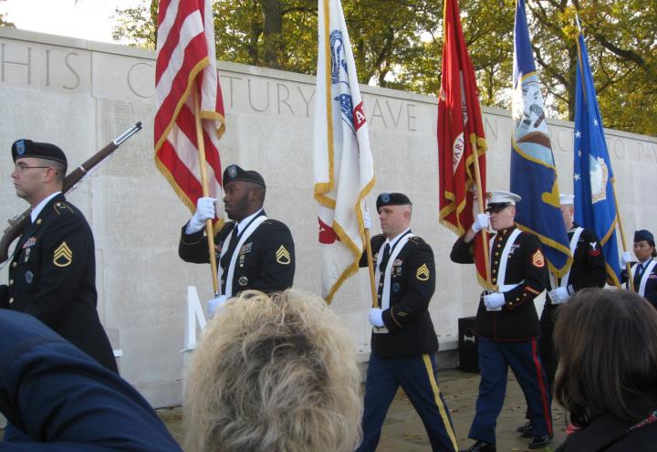 A Joint Honor Guard marches in front of the Walls of Missing during the ceremony. 