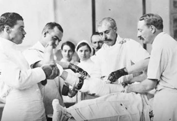 Historic images shows doctors working on a patient. 