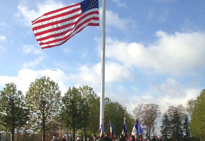 Attendees gathered around the flag pole during the ceremony. 