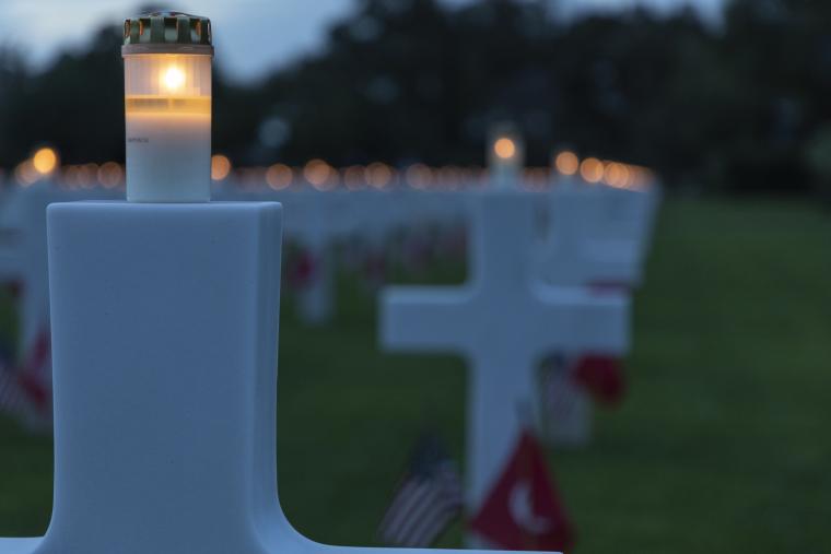 Candles burned on the top of headstones as part of the luminary event. 