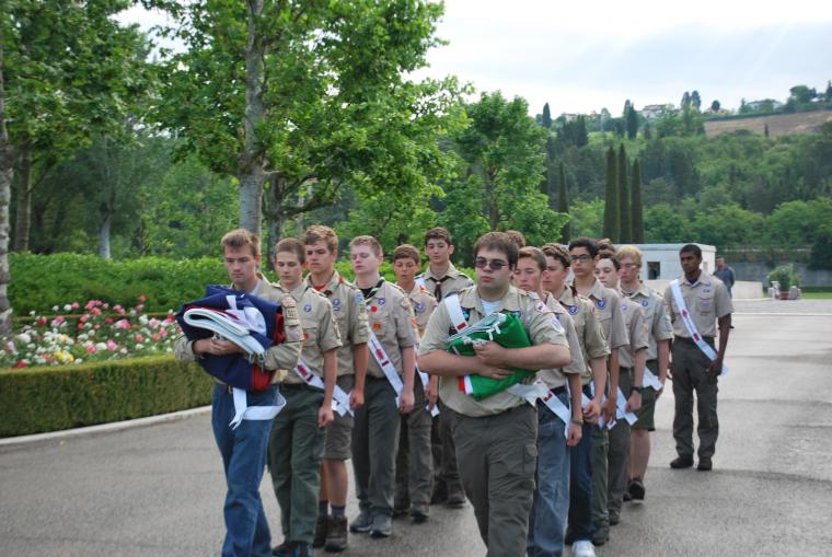 Boy scouts march the folded flags into the cemetery. 