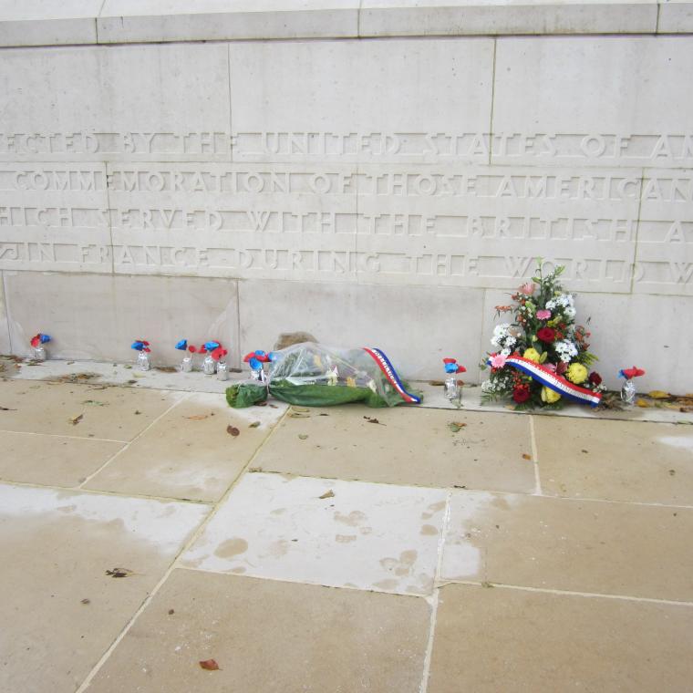 Flowers rest at the base of the Bellicourt American Monument. 