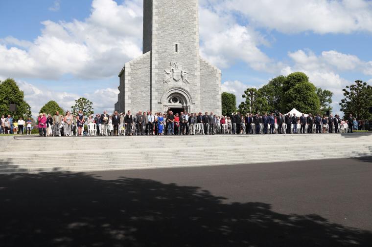 Attendees stand in front of the chapel during the ceremony. 