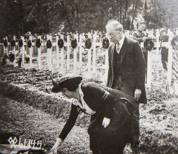 Historical image of President Woodrow Wilson and wife laying wreath at temporary cemetery. 