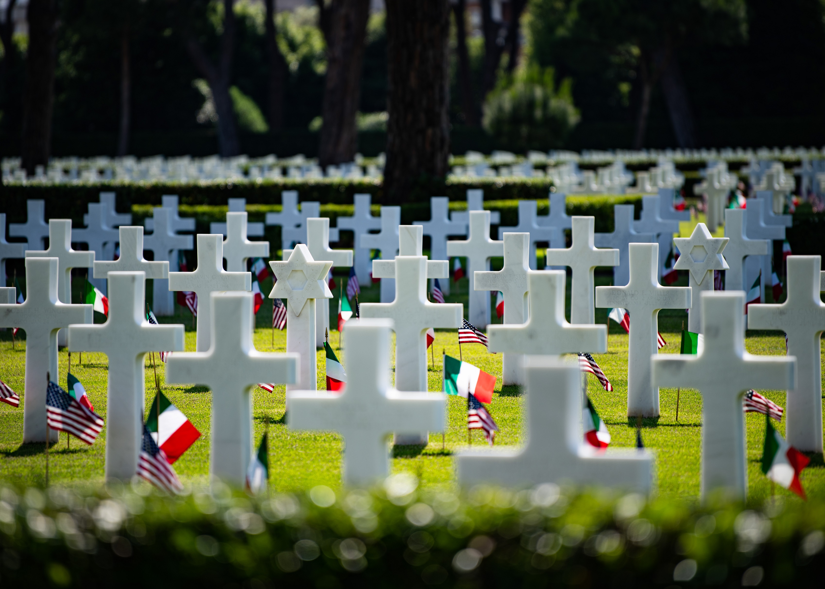 U.S. and Italian flags are placed at the foot of each headstone at Sicily-Rome American Cemetery. Photo: MC1 Cameron C. Edy, U.S. Naval Forces Europe and Africa.