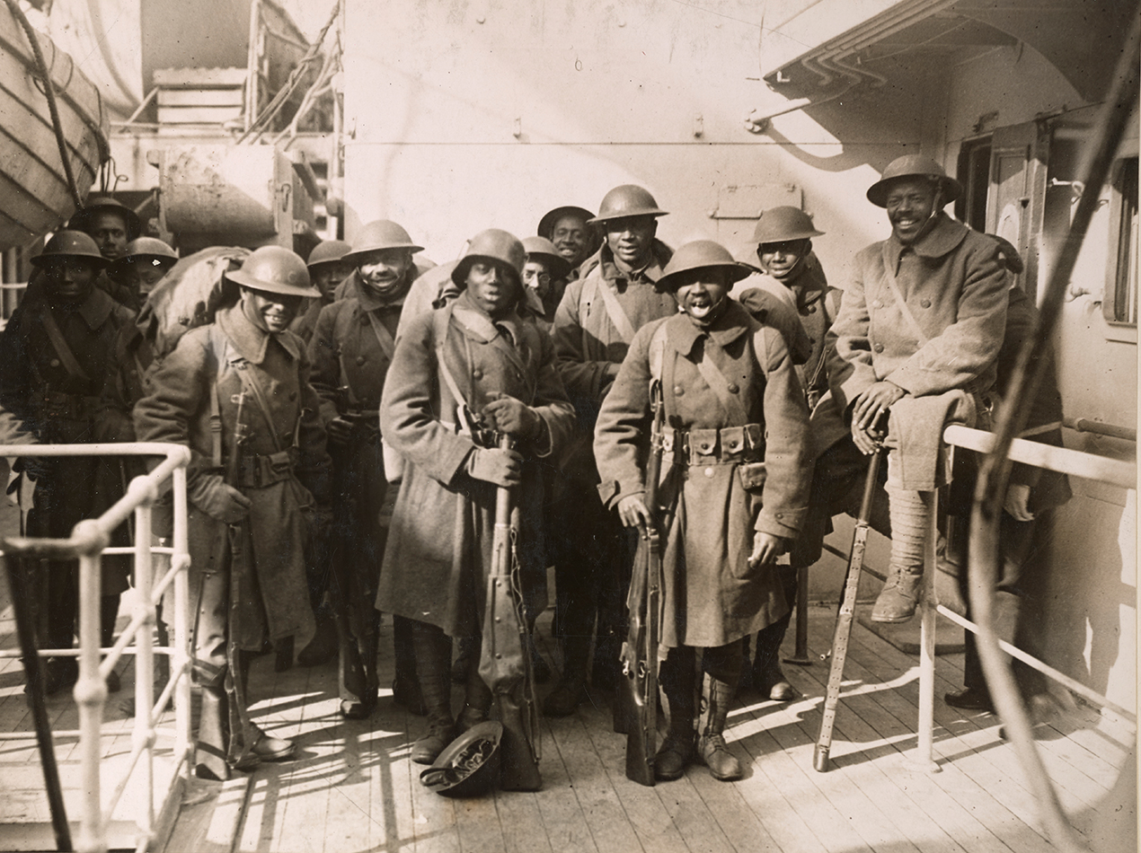 Members of the all-Black 369th, or Harlem Hellfighters, pose on the boat home from World War I after fighting valiantly, Feb. 10, 1919. Photo via National Archives, originally captured by Western Newspapers Union