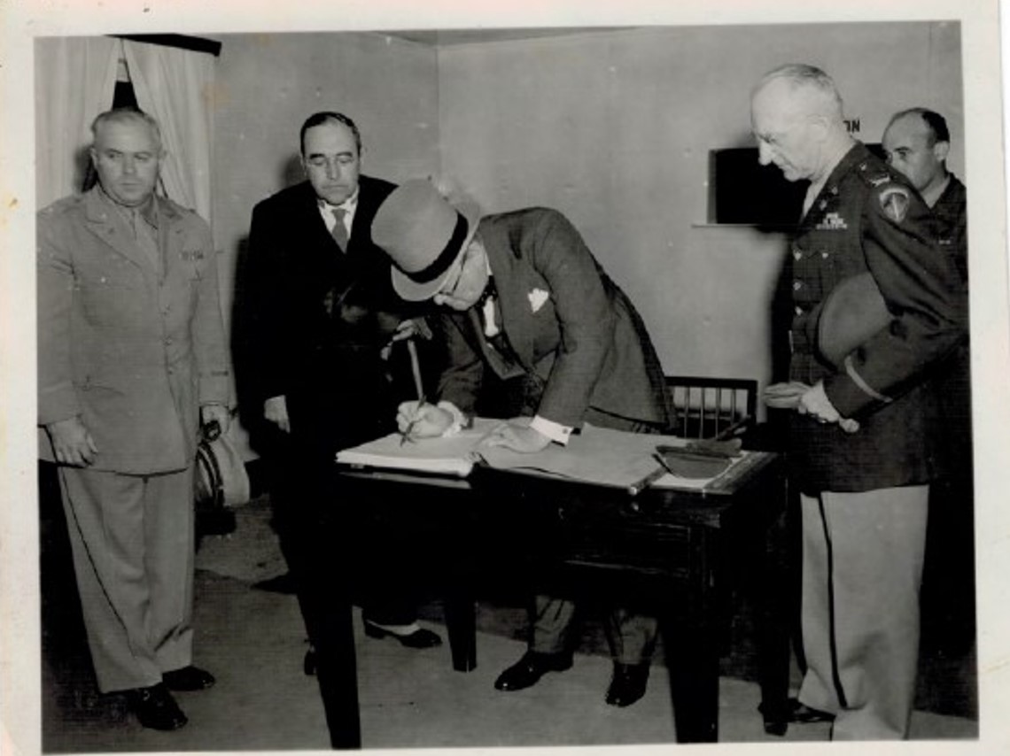 Winston Churchill signing the guest register in the reception building at Luxembourg American Cemetery on July 15, 1946. Credit: American Battle Monuments Commission.