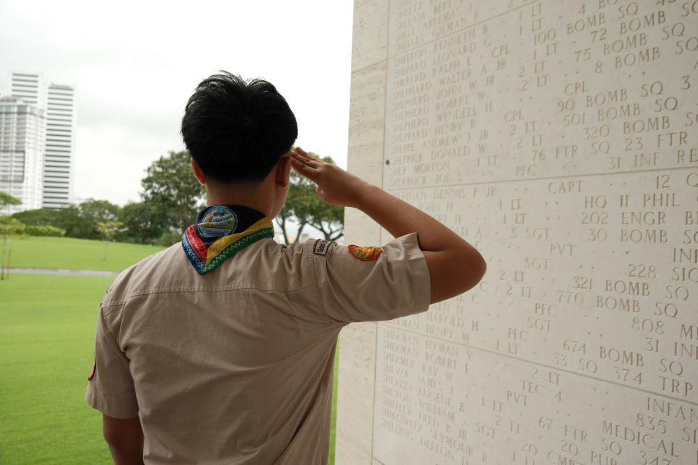 A bronze rosette is placed next to the name of Herman J. Sundstad on the Tablets of the Missing