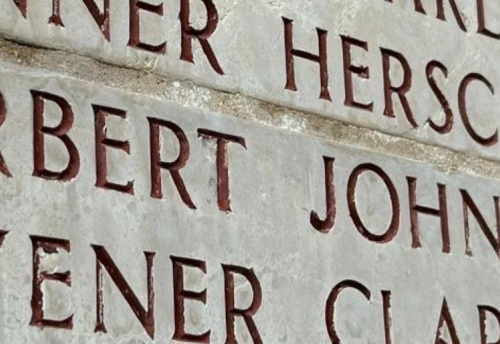 A bronze rosette is placed next to the name of John A. Tarbert at Luxembourg American Cemetery