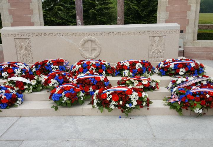 Floral wreaths lay on the steps of the memorial. 