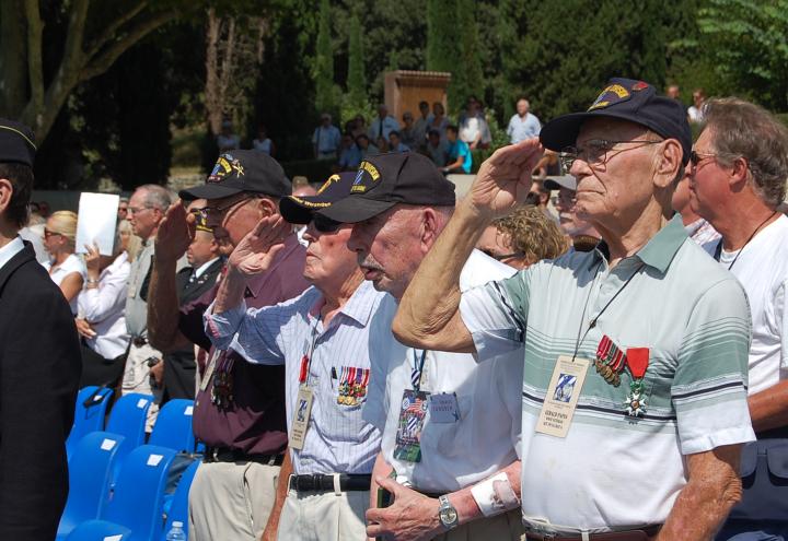 WWII veterans salute during the ceremony. 