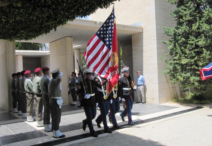A color guard marches in with the American flag. 