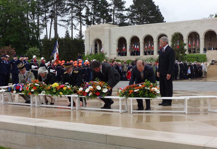 Members of the official party lay floral wreaths during the ceremony. 