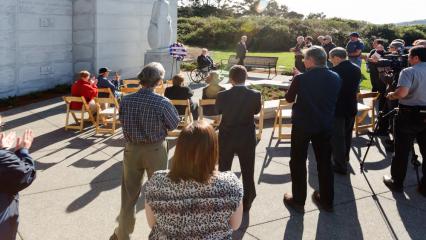 A crowd stands during the ceremony held at the memorial. 
