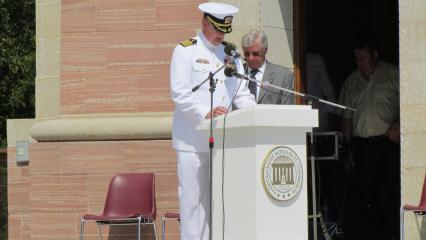 Man in uniform delivers remarks from the podium.
