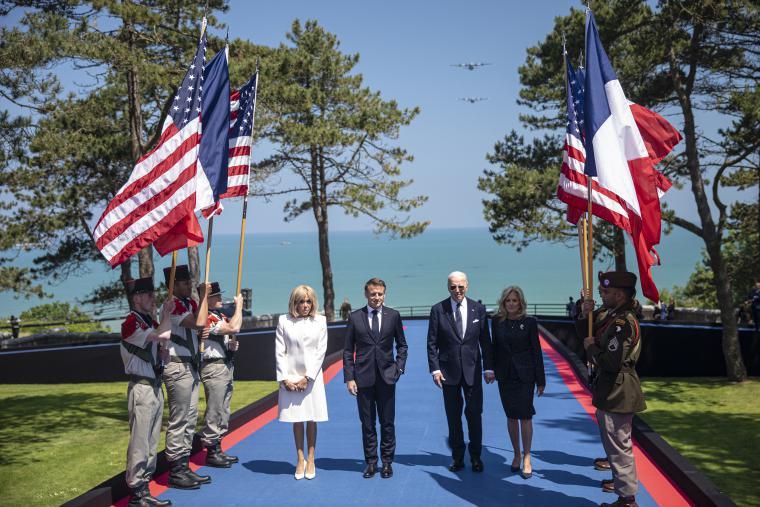 President of the United States Joseph R. Biden Jr. and President of the French Republic Emmanuel Macron, accompanied by their spouses, arrived on stage to honor the nearly 200 WWII veterans