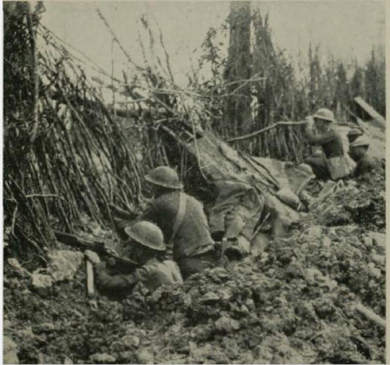 Historic image showing troops in the trenches. 