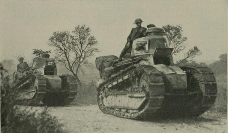 Historic image showing soldiers in tanks. 