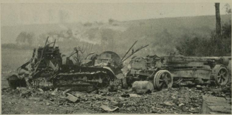 Historic image showing a tractor and 155mm gun put out of action. 