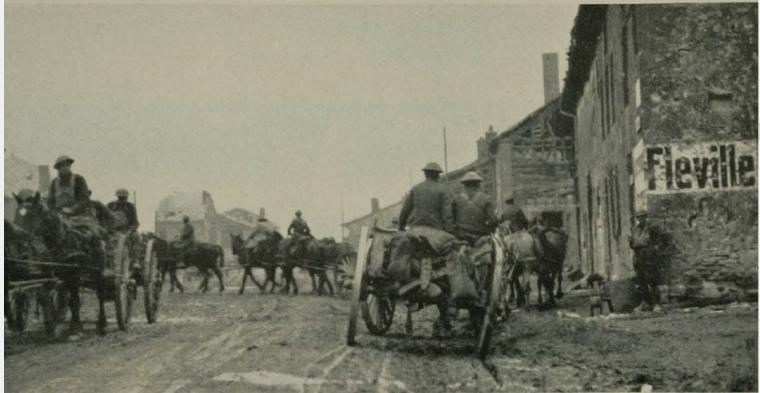 Historic image showing 1st division artillery in the streets of Fleville.