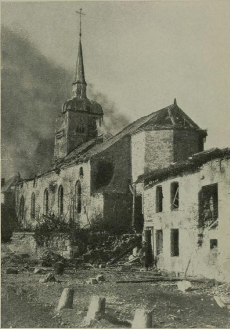 Historic image showing smoke rising from the top of the church. 