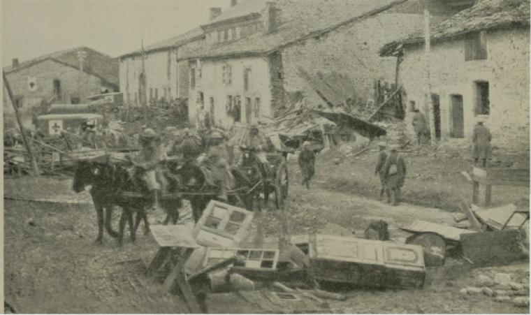 Historic image showing soldiers with horses in destroyed town. 