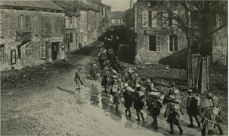 Historic image showing troops marching through town.