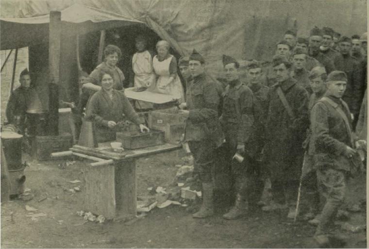 Historic image showing soldiers waiting in line for donuts. 