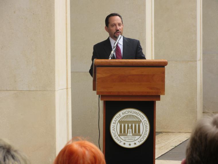 Ambassador Rubinstein delivers remarks from the podium during the ceremony.