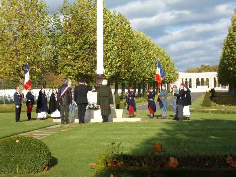 Participants stand near the flag pole after laying the wreaths. 