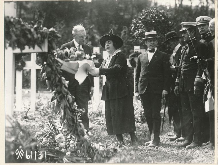 This historic photo shows Wilson and his wife preparing to lay a wreath. 
