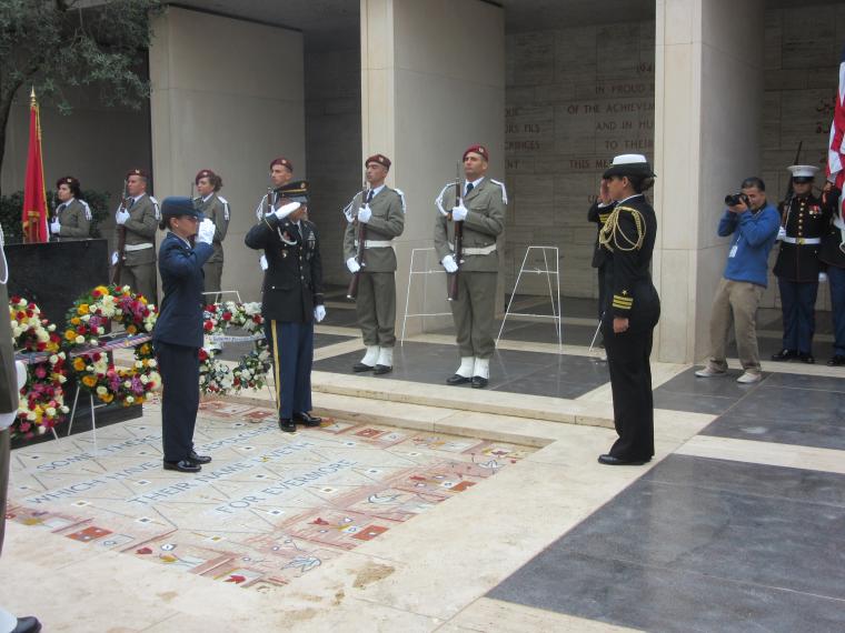 Cmdr. Mollet salutes after laying a wreath during the ceremony. 