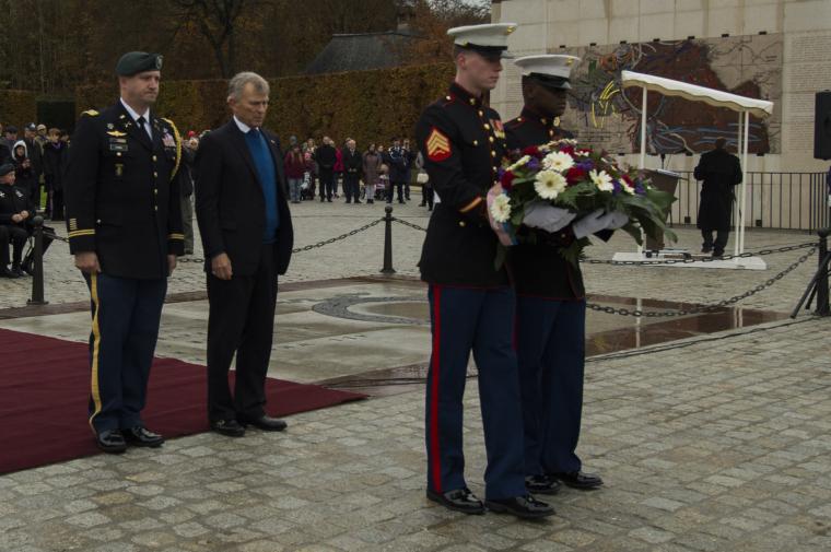 Ambassador McKean stands next to a soldier in uniform before laying a wreath.