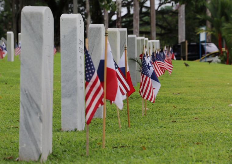 An American and Panamanian flag are in front of every headstone. 