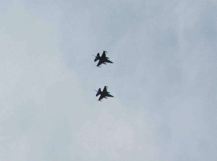 Two F-16s flyover the cemetery during the ceremony. 