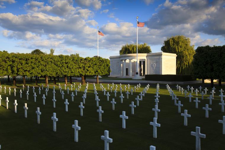 Rows of marble headstones are seen in front of the chapel at St. Mihiel American Cemetery.