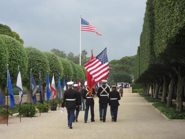 A Marine Honor Guard marches out of the cemetery after the ceremony. 