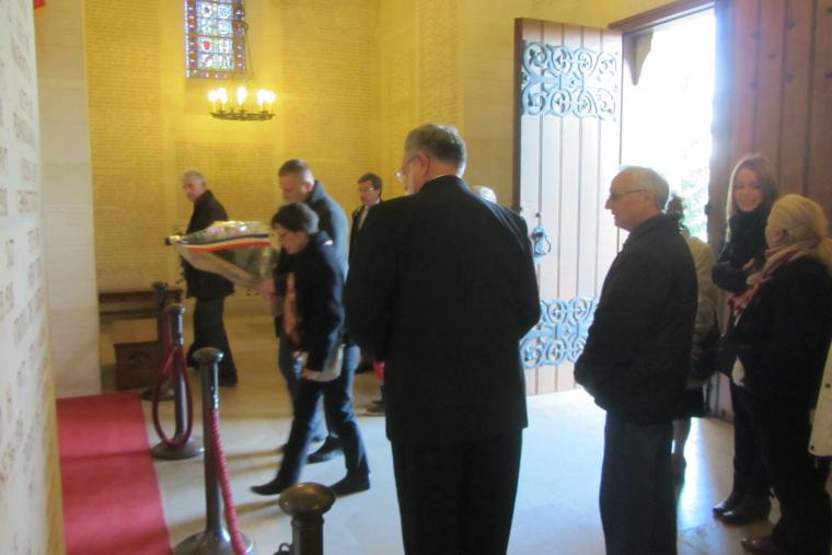 A small group gathers in the chapel for the wreath laying. 