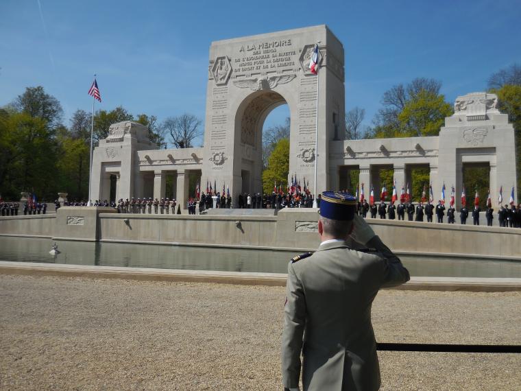 A member of the French military salutes as he faces the memorial. 